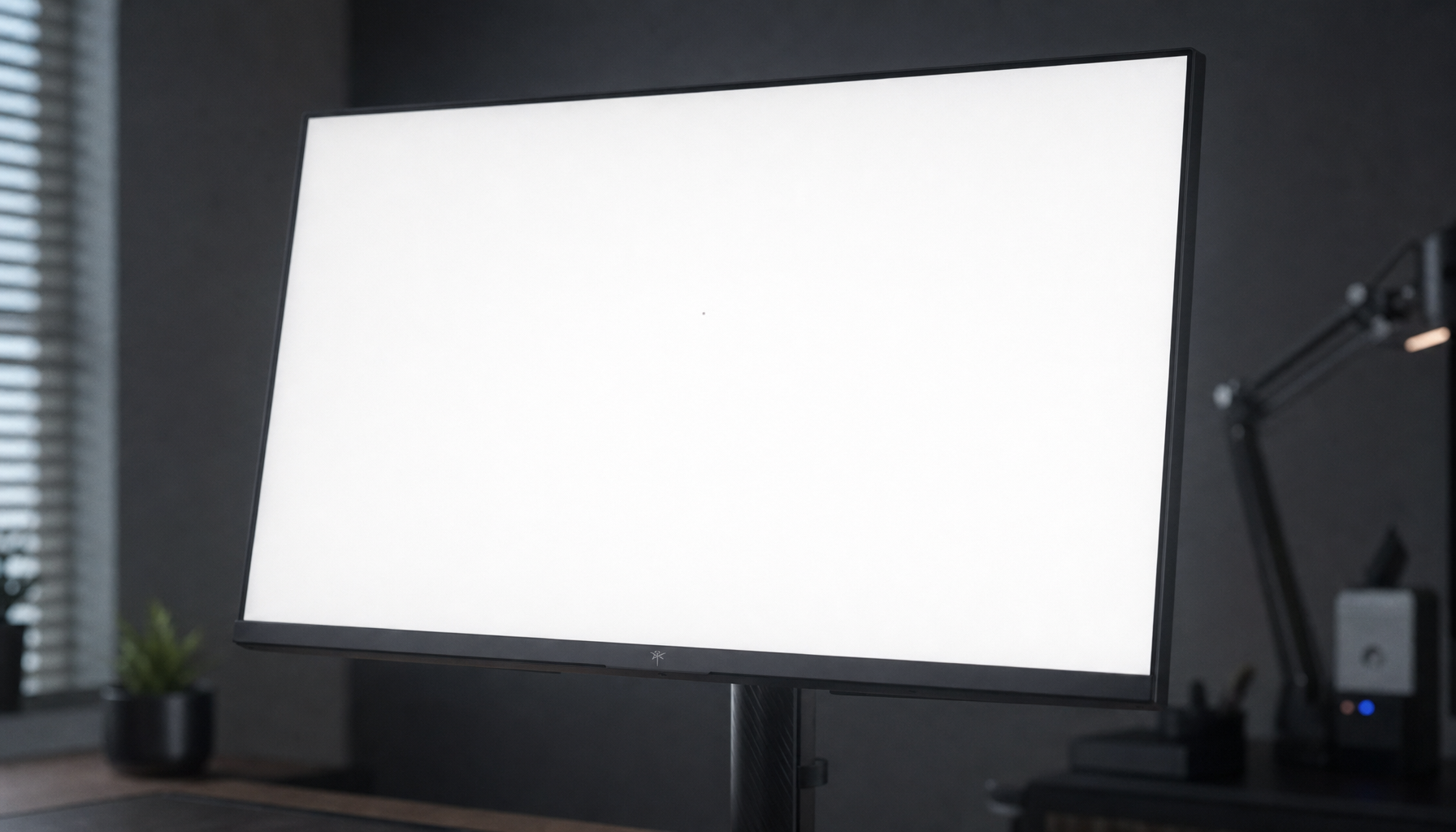 Close-up of a gaming monitor displaying a white test screen to reveal a dead pixel